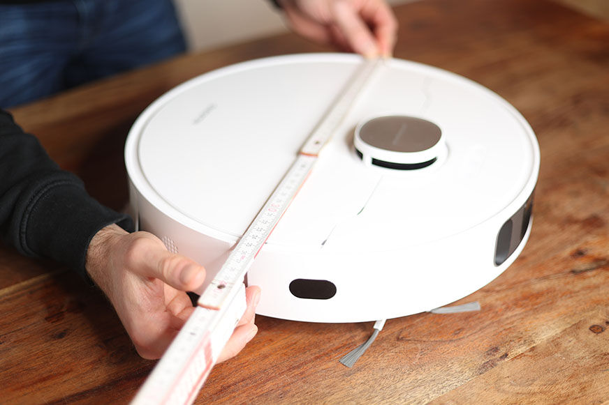 Der Dreame L10s Ultra Saugroboter wird mit einem Lineal ausgemessen.